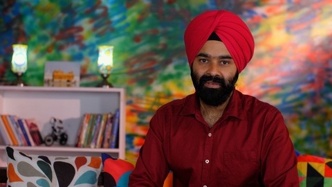 A handsome Sikh man showing a thumbs-up sign while posing for the camera - a modern lifestyle, assurance