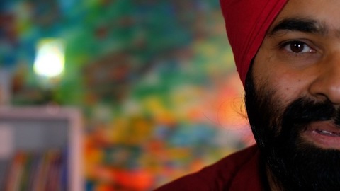 A cheerful Sikh gentleman posing in front of the camera - portrait