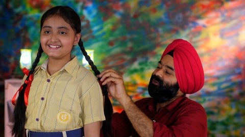 A North Indian Sardar braiding her daughter's hair for school - father-daughter bonding, morning routine