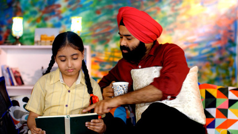 An Indian father helping his daughter with school homework - father-daughter bonding, book reading, me time