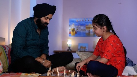 Indian father-daughter playing a board game - playing chess, checkmate, squabbling, mind game