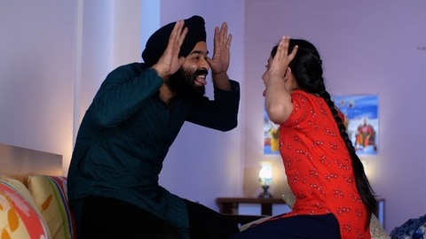 An Indian father-daughter making funny faces while looking at each other - father-daughter bonding, playtime