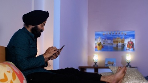 A handsome Punjabi Sardar father checking his girl kid school report card and signing it - single father